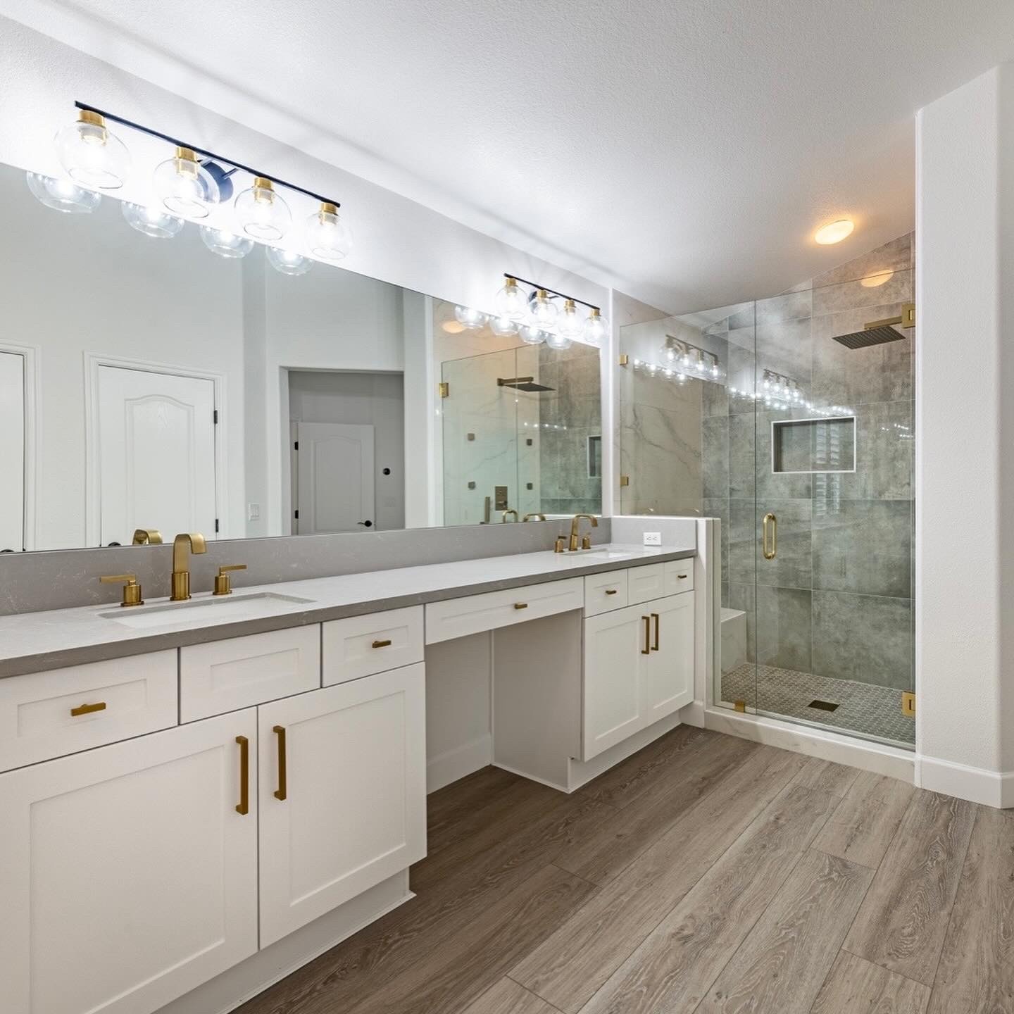 Master bathroom with glass shower and gold fixtures