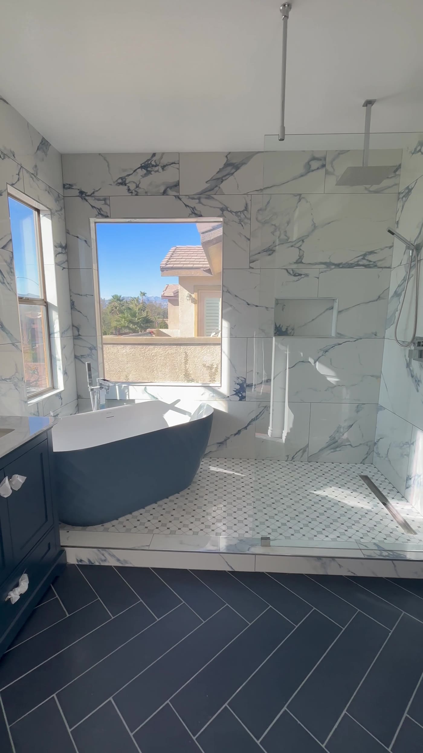 Marble tile walk-in shower with rainfall head